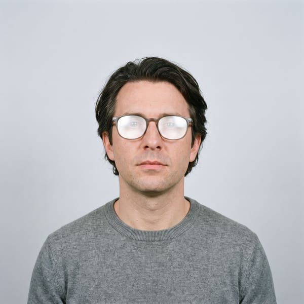 Glasses with a bright reflection hiding both eyes
